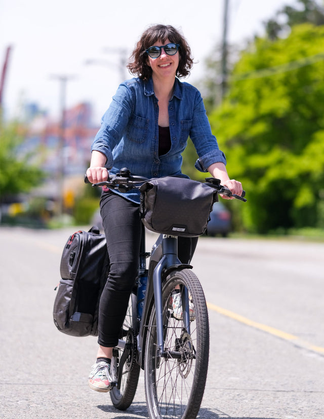 Woman riding her bike with the Two Wheel Gear Alpha SMART Collection Bags. 