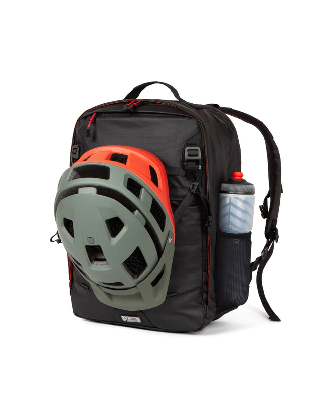 Two Wheel Gear Pannier Backpack Convertible PLUS 30L with Helmet attached and water-bottle in pocket.